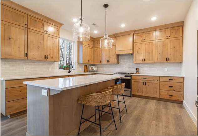 Canyon Cottage kitchen with an 8-foot island, wood cabinets and pendant lights