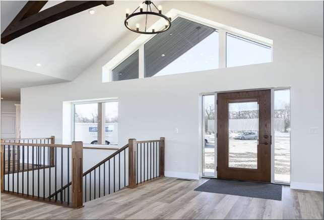 Powder Ridge entry and great room with vaulted ceiling and timber stair rail